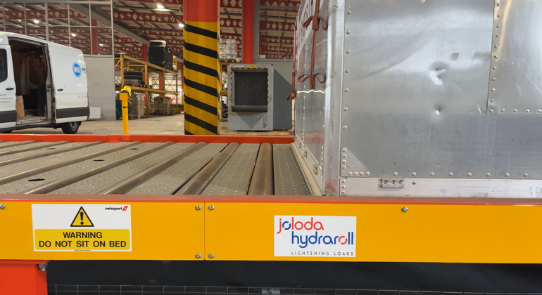 ULD Moving Along Powered Rollerbed From Truck Dock